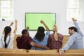 Group Of Young Friends Watching Sports On Television And Cheering Royalty Free Stock Photo
