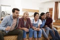 Group Of Young Friends Watching Sports On Television And Cheering Royalty Free Stock Photo