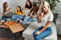 Group of young friends woman eating italian sitting on the sofa