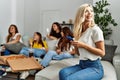 Group of young friends woman eating italian sitting on the sofa