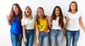 Group of young girl friends standing together over isolated background angry and mad screaming frustrated and furious, shouting Royalty Free Stock Photo