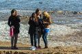 Group of young girls on background of river. People walking in the park. Royalty Free Stock Photo