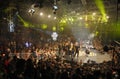 Group of young girls and boys break dancers posing on stage during breakdance battle, crowd of people watching on seats Royalty Free Stock Photo