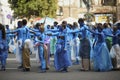 Group of young girls and boys coloured in blue like Avatars standing in the middle of the street