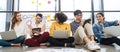 Group of young happy Asian creative business people or hipster student using electronic devices tablet and laptop connection toget Royalty Free Stock Photo