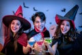 Group of Young Happy Friends Wearing Costumes at Halloween Party Drinking Cocktails and having Fun in Nightclub. Celebration of Royalty Free Stock Photo