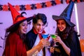 Group of Young Happy Friends Wearing Costumes at Halloween Party Drinking Cocktails and having Fun in Nightclub. Celebration of Royalty Free Stock Photo