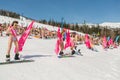 Group of young happy pretty women on a snowboard in colorful bikini with flags. Royalty Free Stock Photo