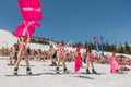 Group of young happy pretty women on a snowboard in colorful bikini with flags. Royalty Free Stock Photo