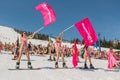 Group of young happy pretty women on a snowboard in colorful bikini with flags. Royalty Free Stock Photo