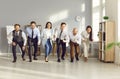 Group of young business people having fun organizing a race during a meeting in office. Royalty Free Stock Photo