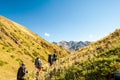 Group of young hikers trekking in mountains. Two women two men backpacking in summer near Sary Chelek lake, Sary-Chelek Jalal Abad