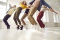 Group of young hip-hop dancers rehearse together and learn new choreography in dance studio.