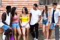 Group of young hipster friends talking in an urban area. Royalty Free Stock Photo