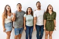 Group of young hispanic friends standing together over isolated background angry and mad screaming frustrated and furious, Royalty Free Stock Photo