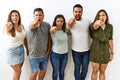 Group of young hispanic friends standing together over isolated background pointing displeased and frustrated to the camera, angry Royalty Free Stock Photo