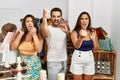 Group of young hispanic people holding shopping bags at clothing shop annoyed and frustrated shouting with anger, yelling crazy Royalty Free Stock Photo