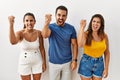 Group of young hispanic people standing over isolated background angry and mad raising fist frustrated and furious while shouting Royalty Free Stock Photo