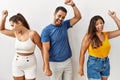 Group of young hispanic people standing over isolated background dancing happy and cheerful, smiling moving casual and confident Royalty Free Stock Photo