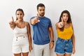 Group of young hispanic people standing over isolated background pointing with finger up and angry expression, showing no gesture Royalty Free Stock Photo