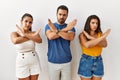 Group of young hispanic people standing over isolated background rejection expression crossing arms doing negative sign, angry Royalty Free Stock Photo