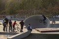 A group of young Iranians ride bicycles in a city skate park