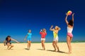 Group of young joyful girls playing volleyball