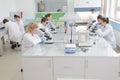 Group of young Laboratory scientists working at lab with test tu