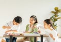 group of young and little children and teacher intend painting color in education classroom, focus at young child. Royalty Free Stock Photo