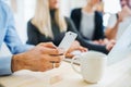 Group of businesspeople with smartphone working together in office, midsection. Royalty Free Stock Photo