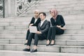 Group young man and woman with hijab sitting and relax on stairs infront modern office