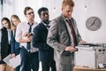 group of young managers standing in queue for copier Royalty Free Stock Photo