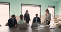 Group of young and mature workmates engaged in morning briefing