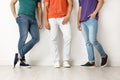 Group of young men in jeans and colorful t-shirts Royalty Free Stock Photo