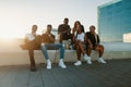 Group of young modern african black friends happily sitting together Royalty Free Stock Photo