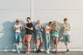 Group of young modern people hanging out together and using their mobile phones Royalty Free Stock Photo