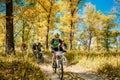 Group Of Young Mountain Bike Cyclist Riding Track At Sunny Day.