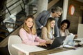 Group of young multiethnic business women working on new project with supervising by the mature boss Royalty Free Stock Photo