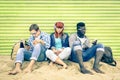 Group of young multiracial friends with smartphone at beach