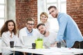 Group of young multiracial people working in modern light office. Businessmen at work during meeting.