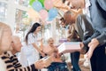 A group of young and old people in a nursing home congratulate an elderly woman on her birthday. Royalty Free Stock Photo