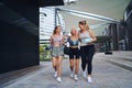 Group of young and old women walking after exercise outdoors in city, talking. Royalty Free Stock Photo