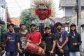 a group of young people accompanying ondel ondel with Betawi cultural music.