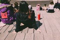 Group of young people attend an outdoor show, seen from behind unrecognizable