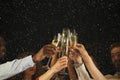 Group of young people celebrating new year with champagne at night club