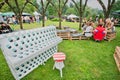 Group of young people chatting on the green yard with piano