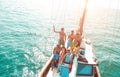 Group of young people dancing in sailing boat party with dj playing music - Top view of multiracial friends having fun in summer Royalty Free Stock Photo