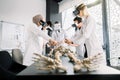 Group of young people of different sex, race, in medical clothes, medical students, scientists, archeologists, study the