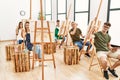 Group of young people drawing at art studio annoyed and frustrated shouting with anger, yelling crazy with anger and hand raised Royalty Free Stock Photo