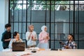 a group of young people enjoying doing assignments together